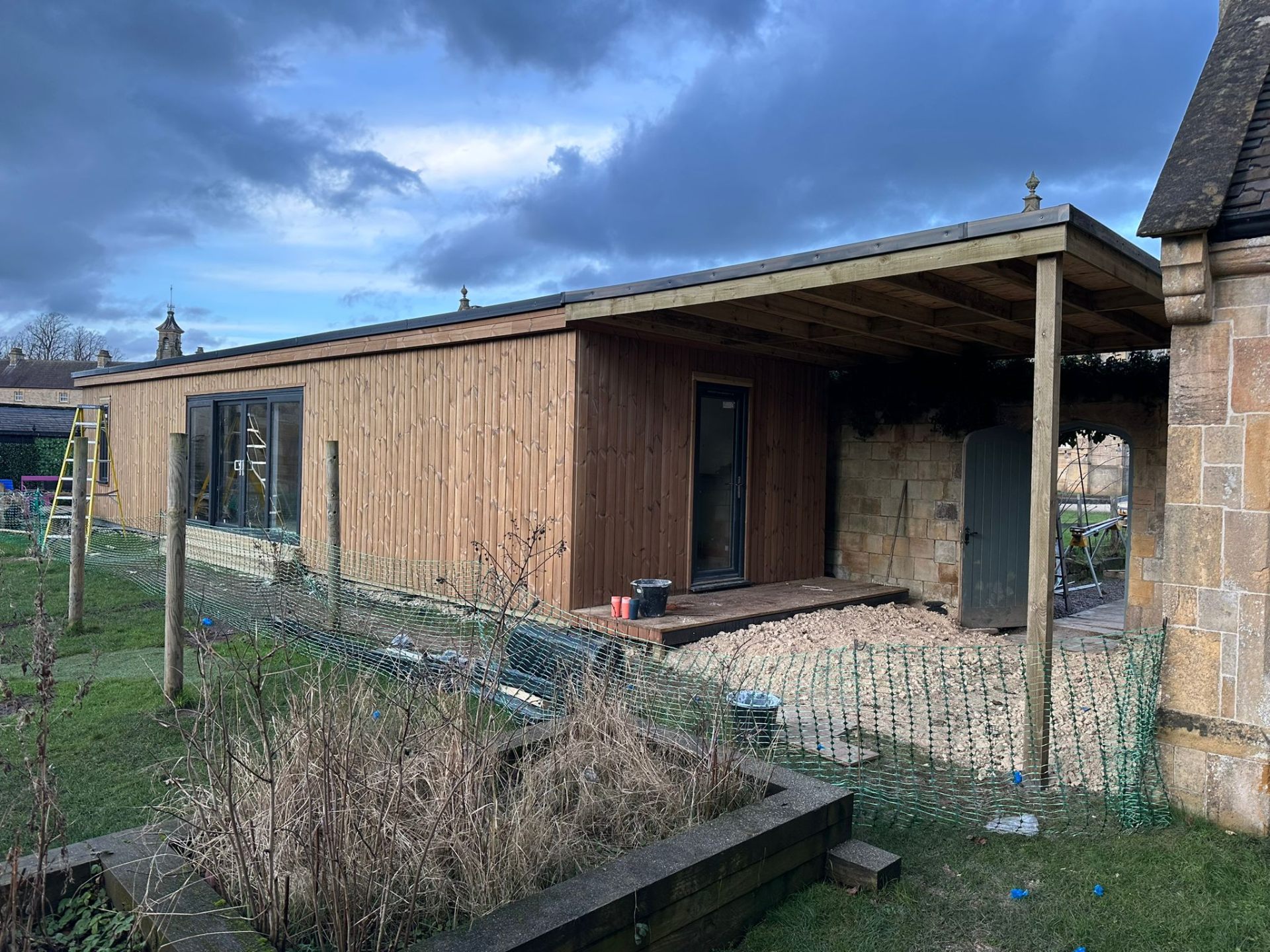 Cedar-clad garden room with overhanging roof in Nottinghamshire