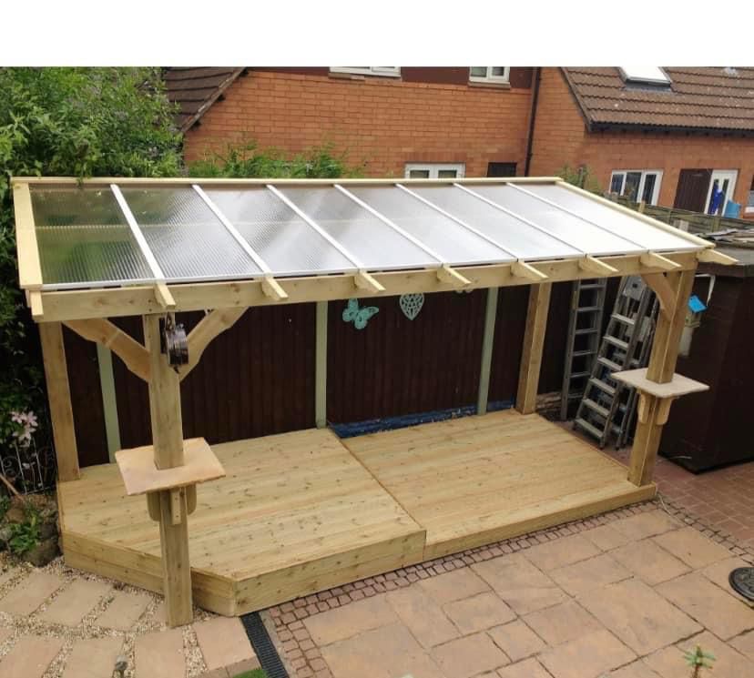 Timber gazebo with polycarbonate roof over a paved patio