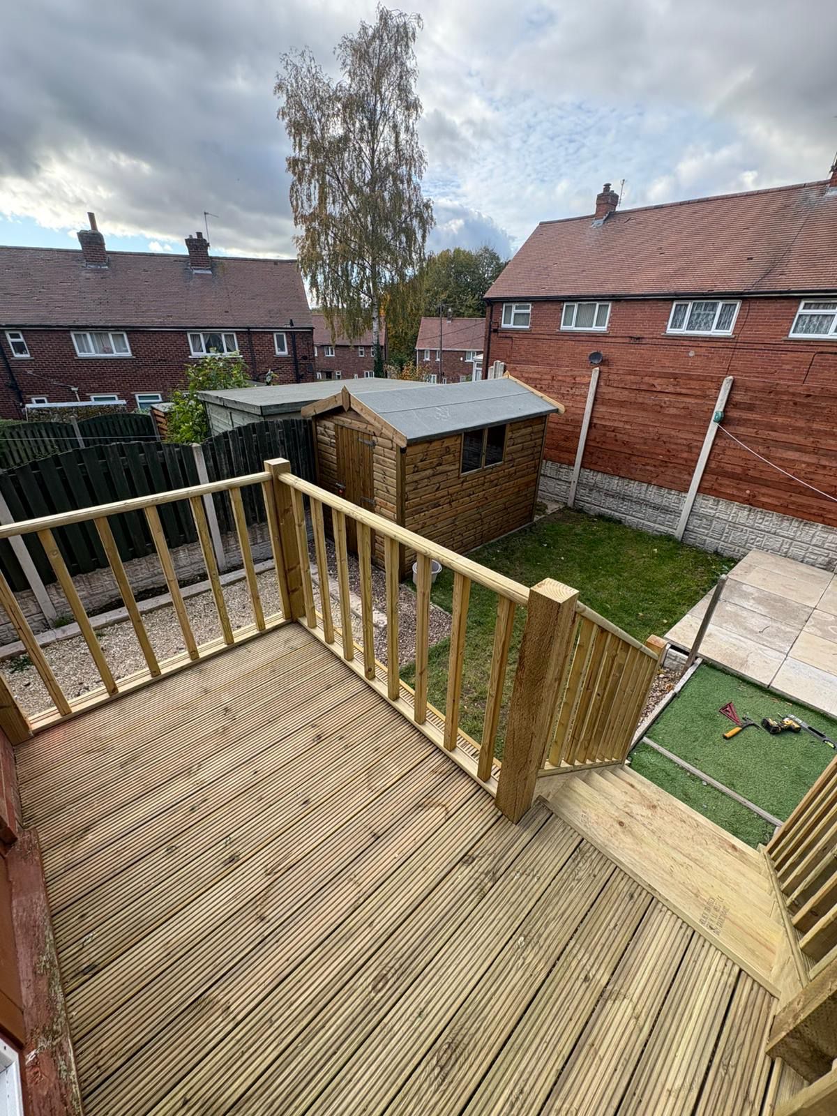 Raised timber decking project with balustrades in a back garden