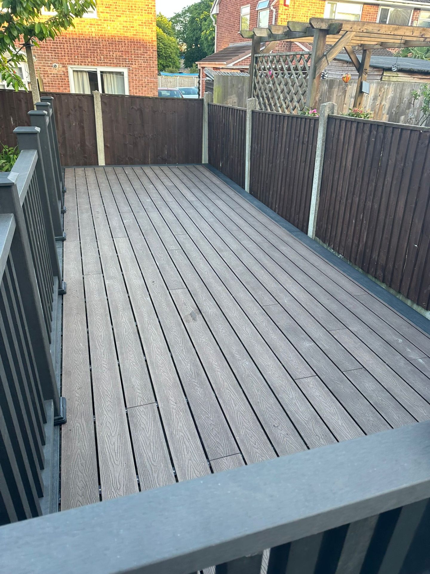 Grey composite decking installation with fence in Nottinghamshire